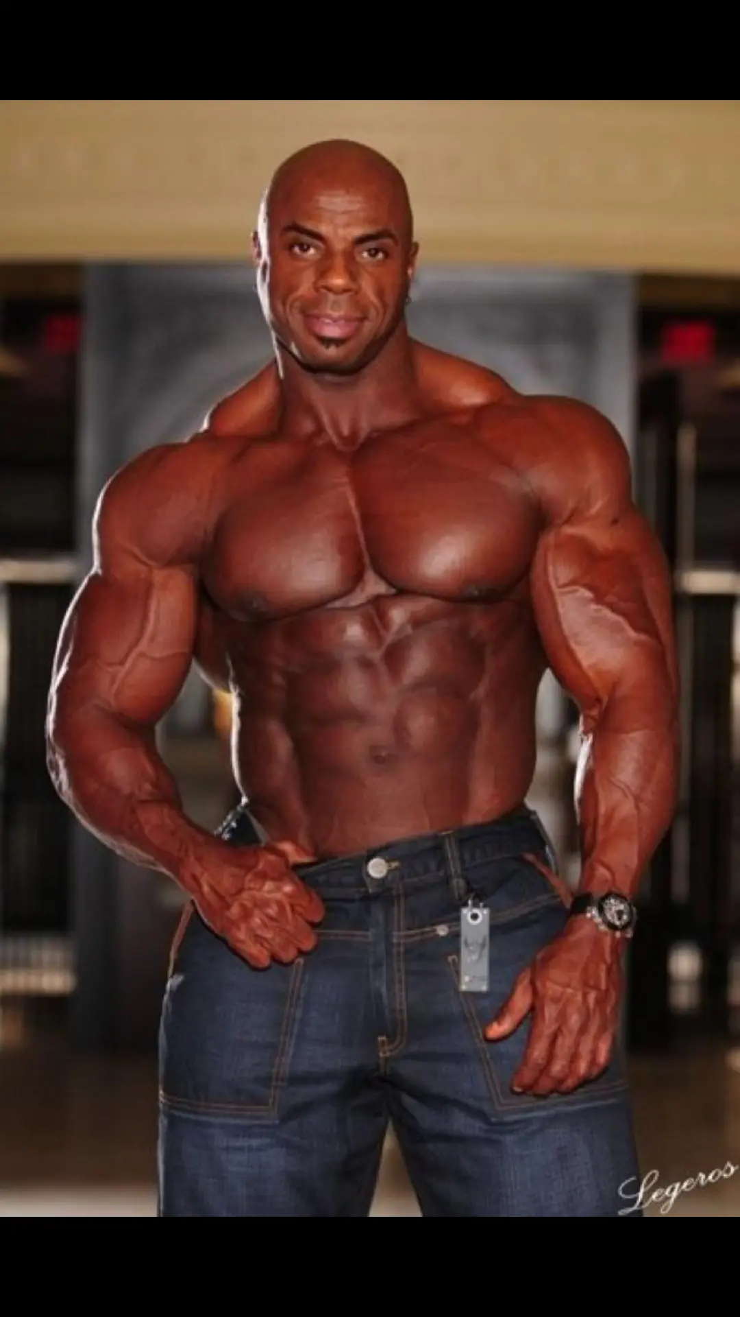 Toney Freeman standing shirtless in jeans showing his X-frame physique